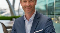 Firefly a corporate headshot of a man in his 40s in the international conference center in vienna 17.jpg