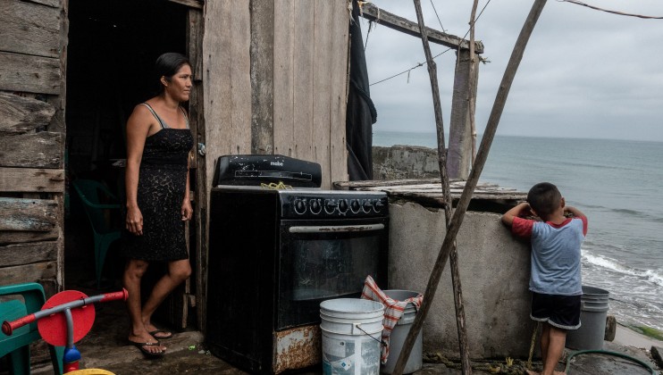 Mrs. Marlit watches her son while he plays, in the community of Sanchez Magallanez. More than half of her house now no longer exists. The sea destroyed it. Now, she and her family live in two small rooms hoping that this part does not get swept out into the sea as well. Date: 2021.09.02 Photo: César Rodríguez/Norwegian Red Cross.
