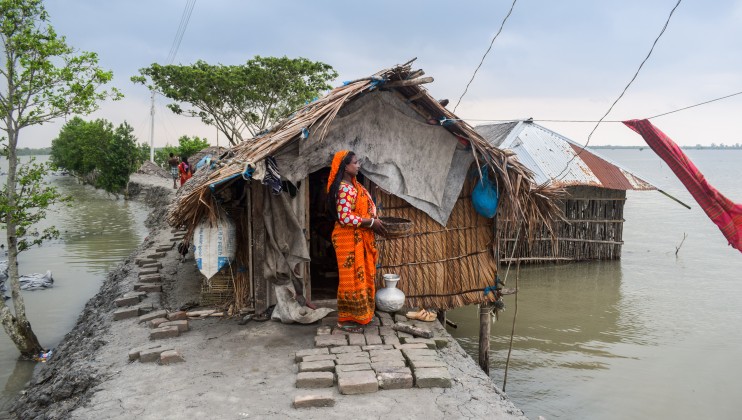 Renuka Rani Mandal, 37, lost her house recently during Cyclone Yaas in May 2021, and now lives in a small shelter precariously built on an embankment. This small home is the last resource Renuka and her family have. Renuka lives in a village in Koira upazila (sub-district) of Khulna, a district in Southwest Bangladesh. Her family has been displaced four times in her lifetime, losing everything every time. Renuka worries this will keep getting worse and is considering relocating inland to be safe from the ravages of climate change.  Photo: Rafiqul Islam Montu/Norwegian Red Cross