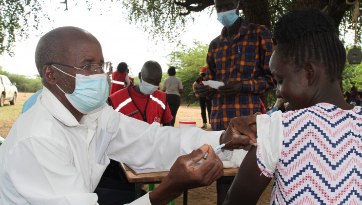 Baringo County, Kenya, 2021.  A doctor administers the COVID19 vaccine in the community with the support of Red Cross volunteers